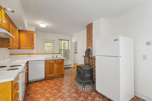 44 Pascal Ave, Rockport, ME 04856 - kitchen with white appliances, a sink, a baseboard heating unit, a wood stove, and light countertops