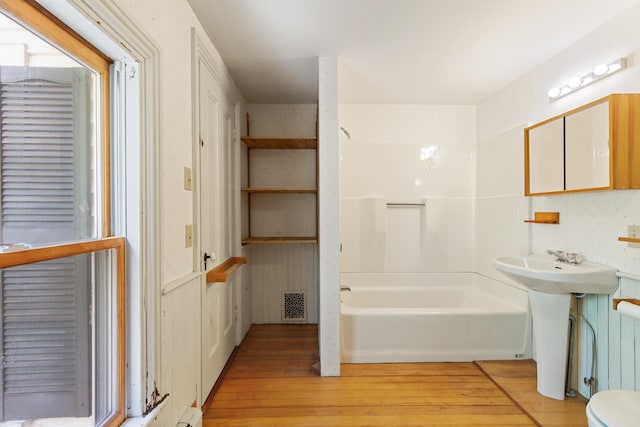 44 Pascal Ave, Rockport, ME 04856 - full bathroom featuring wood-type flooring, washtub / shower combination, toilet, and a sink