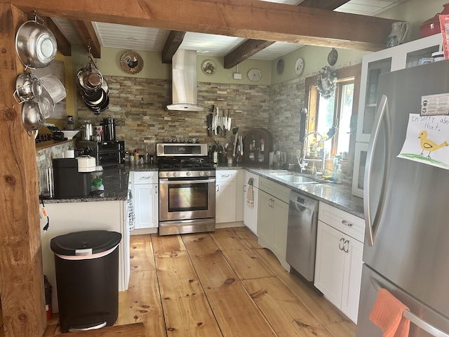 1363 Hallowell Rd, Litchfield, ME 04350 - kitchen featuring appliances with stainless steel finishes, wall chimney range hood, a sink, tasteful backsplash, and light wood finished floors