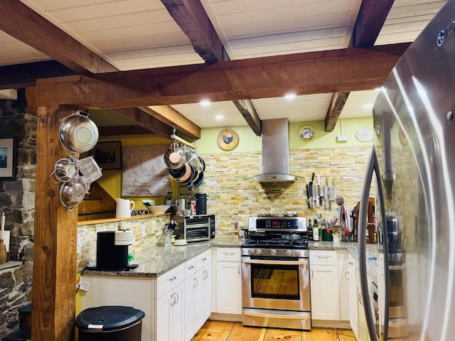1363 Hallowell Rd, Litchfield, ME 04350 - kitchen with stainless steel appliances, wall chimney range hood, beamed ceiling, tasteful backsplash, and white cabinets