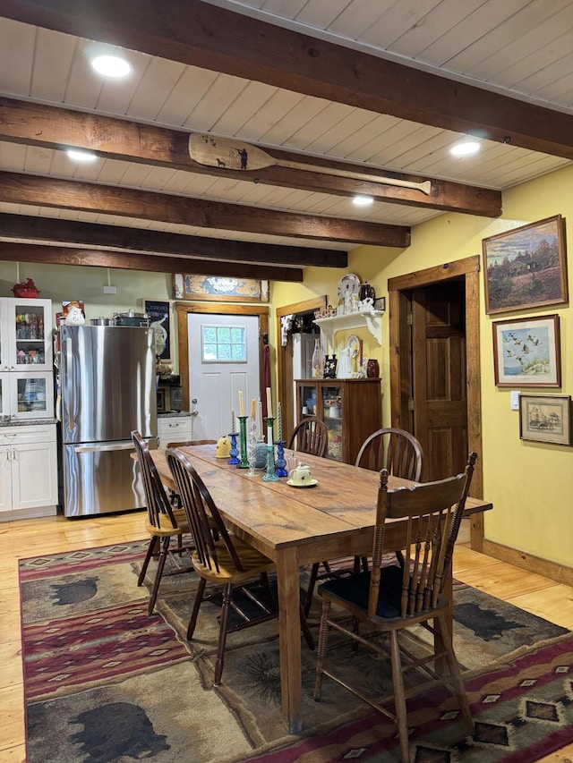 1363 Hallowell Rd, Litchfield, ME 04350 - dining space featuring light wood-type flooring, beamed ceiling, wood ceiling, and baseboards