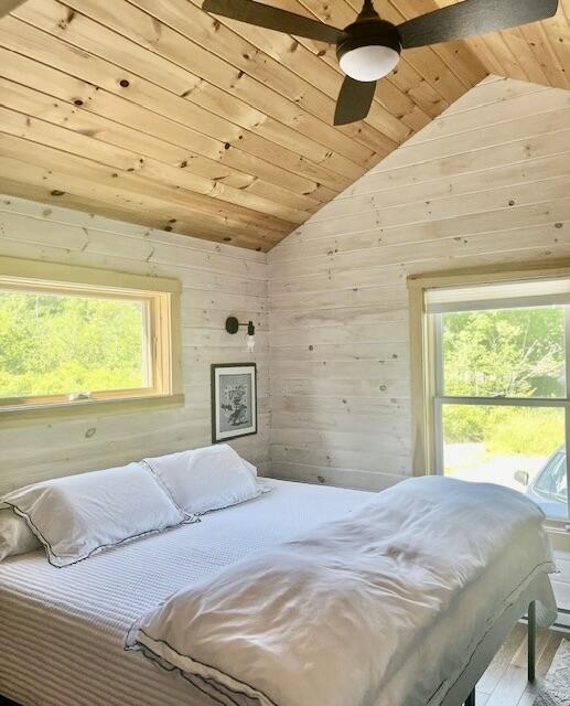 26 Hamilton Dr, Vinalhaven, ME 04863 - bedroom featuring wooden ceiling, vaulted ceiling, multiple windows, wood walls, and wood finished floors