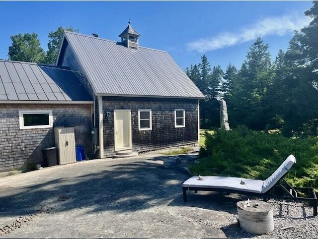26 Hamilton Dr, Vinalhaven, ME 04863 - back of house with metal roof, a standing seam roof, and entry steps