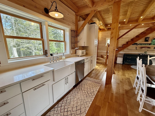 26 Hamilton Dr, Vinalhaven, ME 04863 - kitchen with stainless steel dishwasher, wood ceiling, wooden walls, white microwave, and light wood-type flooring