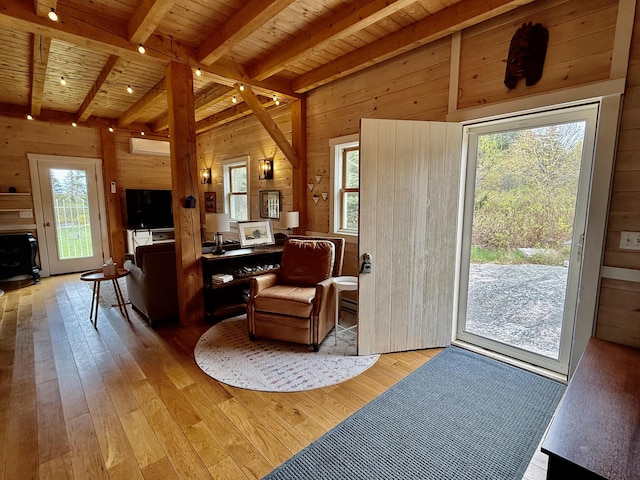 26 Hamilton Dr, Vinalhaven, ME 04863 - living room featuring wood walls, wooden ceiling, beamed ceiling, light wood-style flooring, and healthy amount of natural light