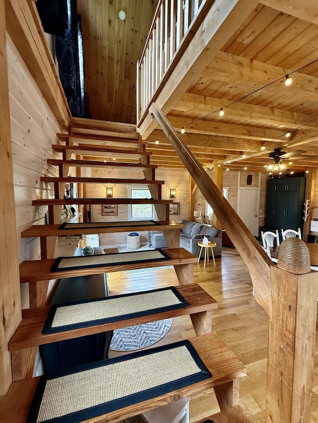 26 Hamilton Dr, Vinalhaven, ME 04863 - staircase with wood walls, wood finished floors, wooden ceiling, beam ceiling, and a ceiling fan