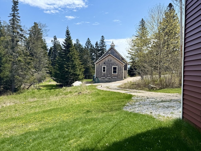 26 Hamilton Dr, Vinalhaven, ME 04863 - view of green lawn with dirt driveway