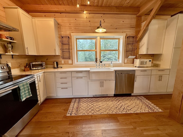 26 Hamilton Dr, Vinalhaven, ME 04863 - kitchen with appliances with stainless steel finishes, wooden ceiling, a sink, light wood-style flooring, and white cabinetry