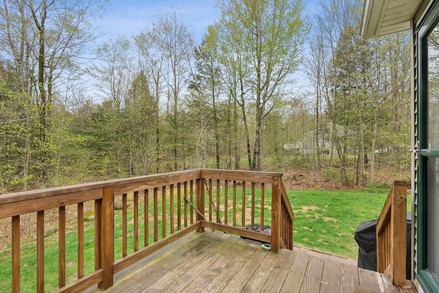 wooden deck featuring a yard