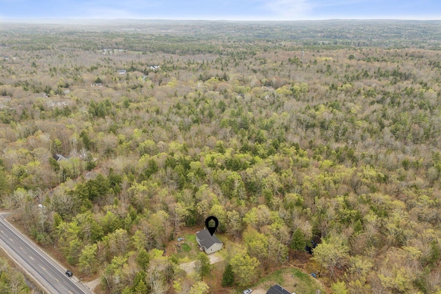 aerial overview of property's location with a heavily wooded area