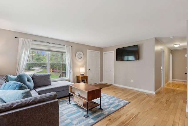 living room with light wood-style flooring and baseboards