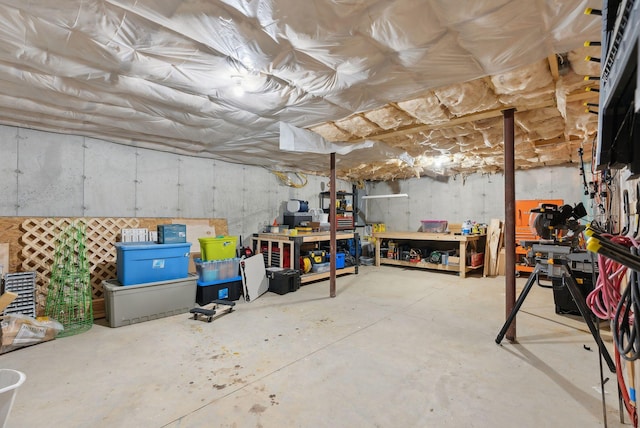 unfinished basement featuring a workshop area