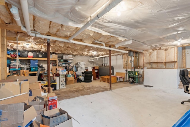 unfinished basement featuring a heating unit and heating fuel