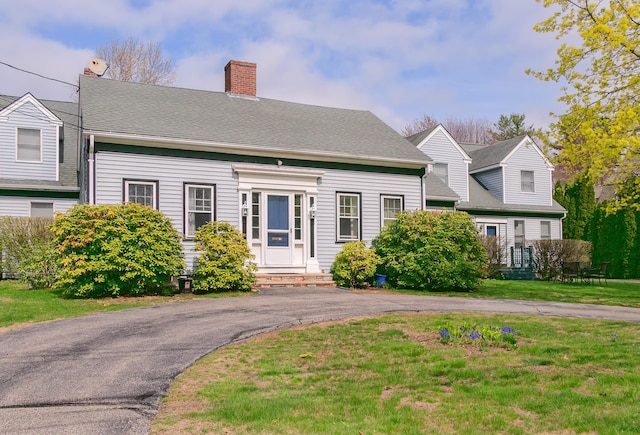 63 Fletcher St, Kennebunk, ME 04043 - cape cod house with a front lawn, a chimney, and entry steps