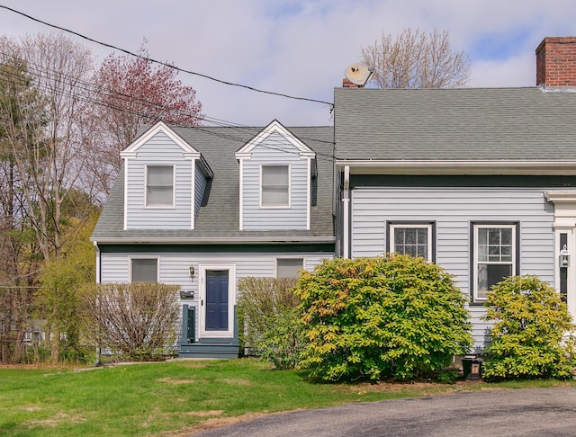 63 Fletcher St, Kennebunk, ME 04043 - cape cod-style house with a front yard, a chimney, and roof with shingles