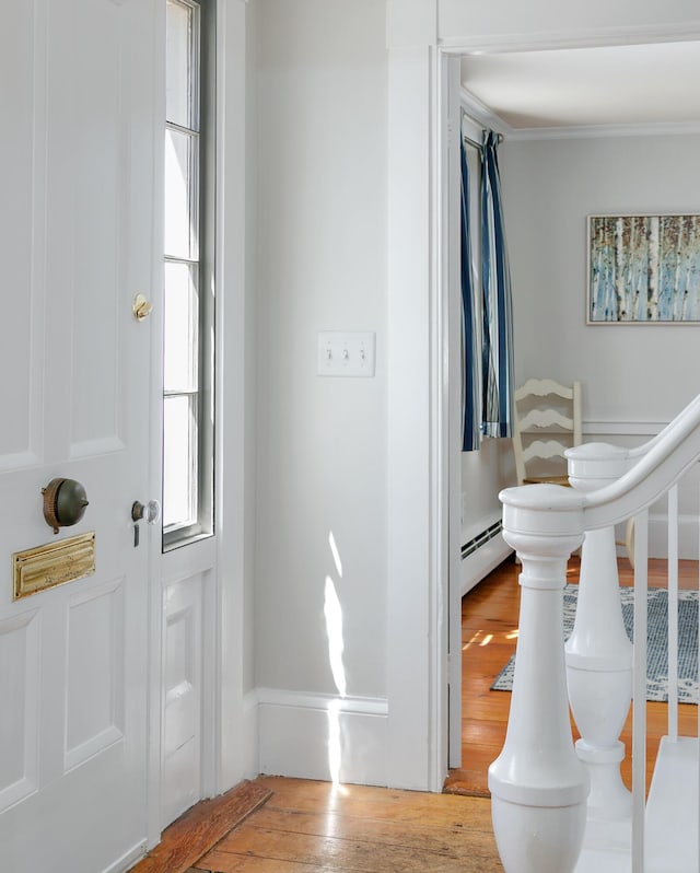 63 Fletcher St, Kennebunk, ME 04043 - foyer entrance featuring hardwood / wood-style floors, ornamental molding, and a baseboard radiator