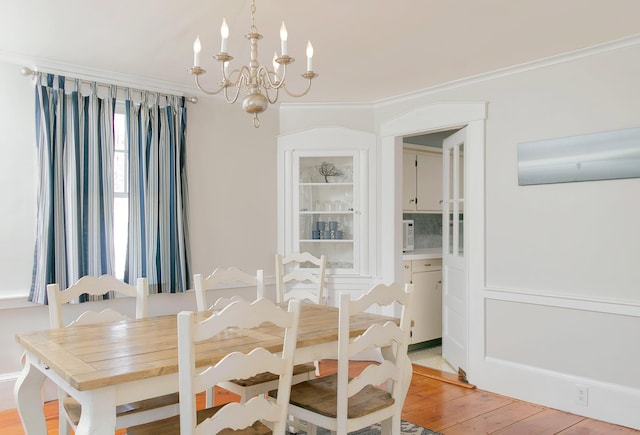 63 Fletcher St, Kennebunk, ME 04043 - dining space featuring a chandelier, crown molding, light wood-type flooring, and an AC wall unit