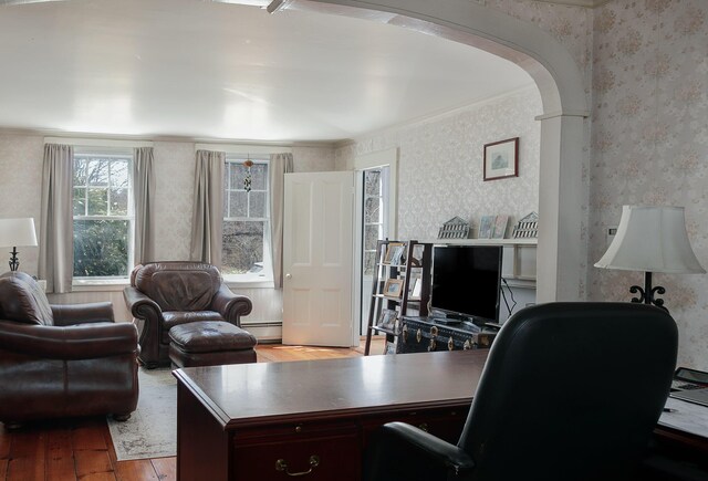 63 Fletcher St, Kennebunk, ME 04043 - office area featuring wallpapered walls, hardwood / wood-style flooring, arched walkways, crown molding, and a baseboard heating unit