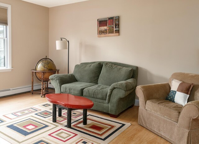 63 Fletcher St, Kennebunk, ME 04043 - sitting room featuring light wood finished floors and a baseboard heating unit