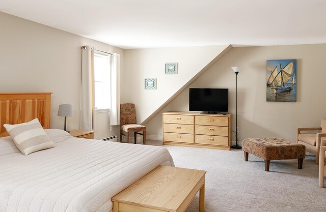 63 Fletcher St, Kennebunk, ME 04043 - bedroom with light colored carpet and a baseboard radiator