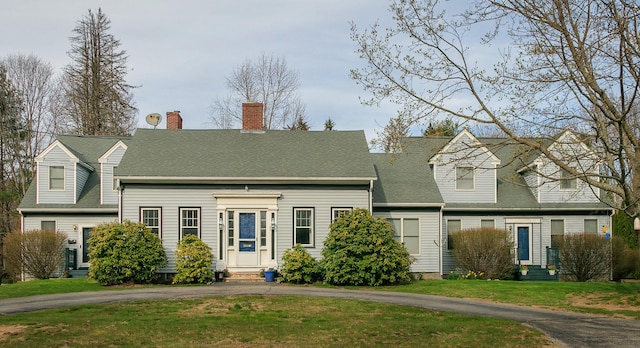 63 Fletcher St, Kennebunk, ME 04043 - new england style home featuring entry steps, a front yard, driveway, and a chimney