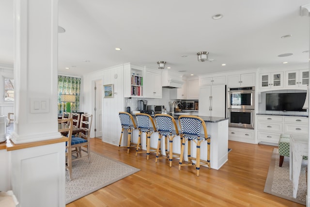 1 Harris Ln, Kennebunk, ME 04043 - kitchen featuring light wood-style floors, stainless steel double oven, and white cabinets