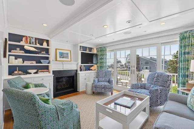 1 Harris Ln, Kennebunk, ME 04043 - living area featuring light wood finished floors, plenty of natural light, beamed ceiling, and a fireplace with flush hearth