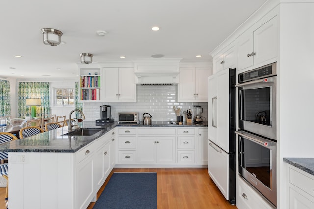 1 Harris Ln, Kennebunk, ME 04043 - kitchen with a peninsula, double oven, white cabinets, and a sink