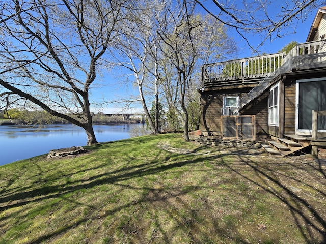 view of yard featuring a deck with water view