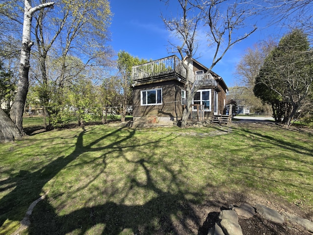 exterior space featuring a yard and a balcony