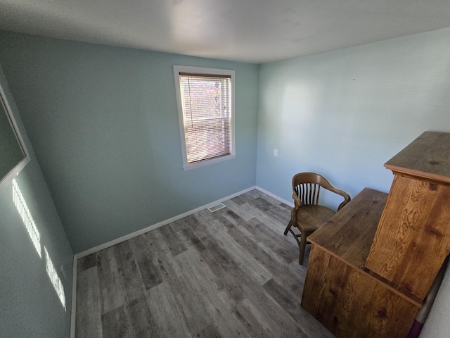 sitting room with visible vents, wood finished floors, and baseboards