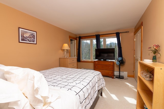 bedroom featuring light colored carpet and baseboard heating
