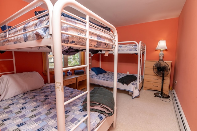 bedroom with baseboard heating and carpet floors