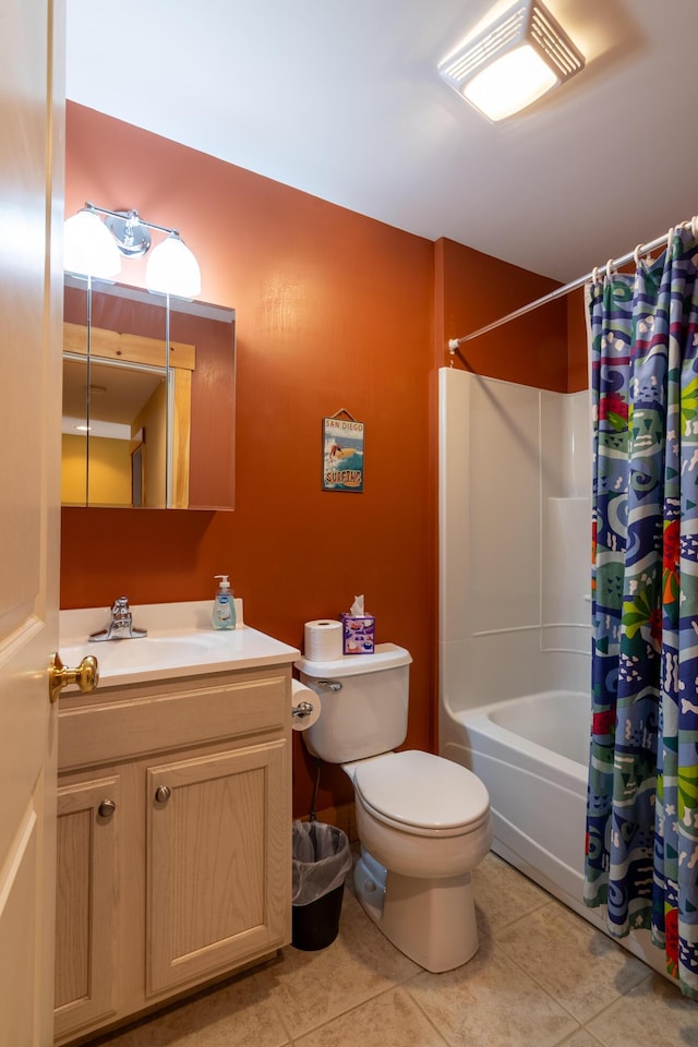 full bathroom featuring toilet, tile patterned floors, vanity, and shower / bath combo with shower curtain