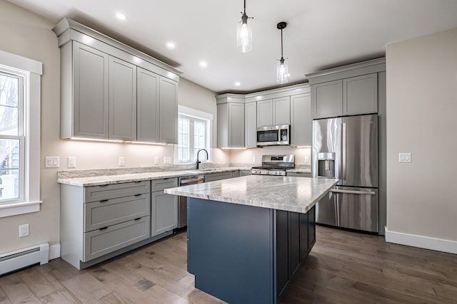 kitchen featuring stainless steel appliances, gray cabinetry, baseboard heating, and recessed lighting