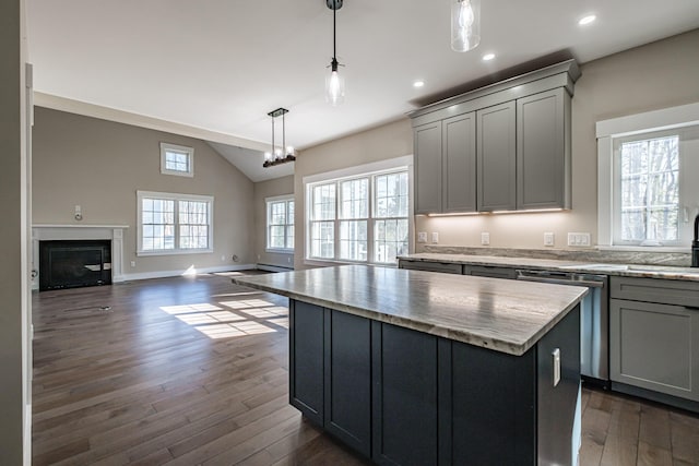 kitchen featuring dishwasher, dark wood-style floors, a kitchen island, open floor plan, and gray cabinets