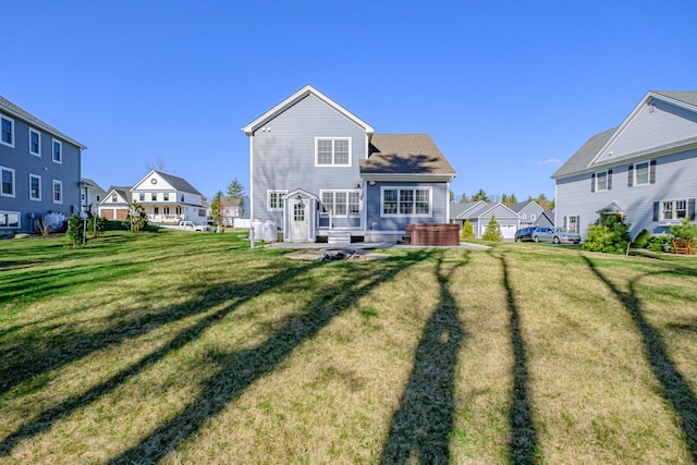 rear view of property featuring a residential view and a yard