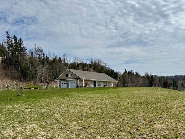 35 Carson Ln, Fort Kent, ME 04743 - view of yard featuring a wooded view and a garage