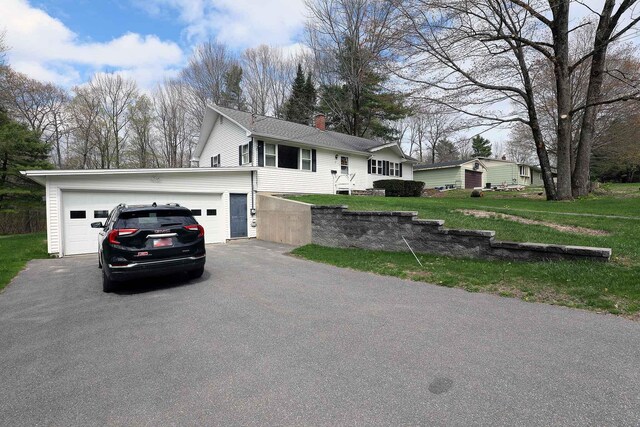 view of front of property with a chimney and a front lawn