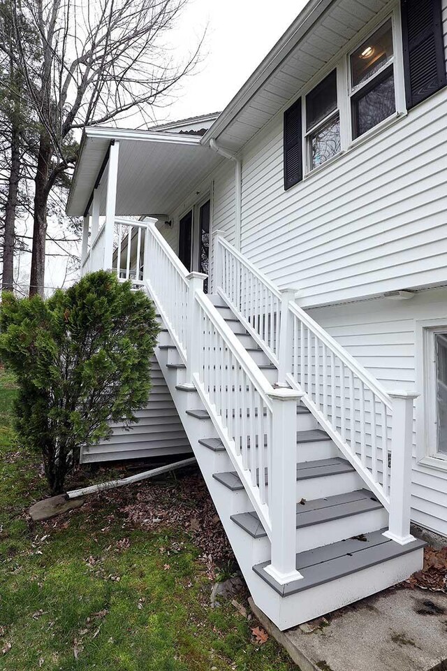 view of side of property featuring stairs