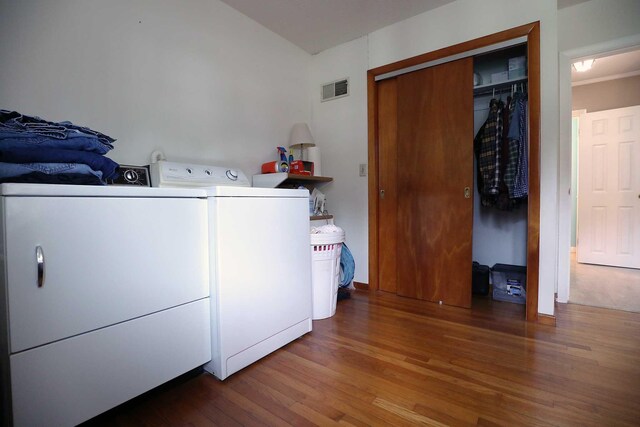 washroom featuring independent washer and dryer and wood finished floors