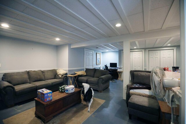 living area with concrete flooring, a desk, and recessed lighting