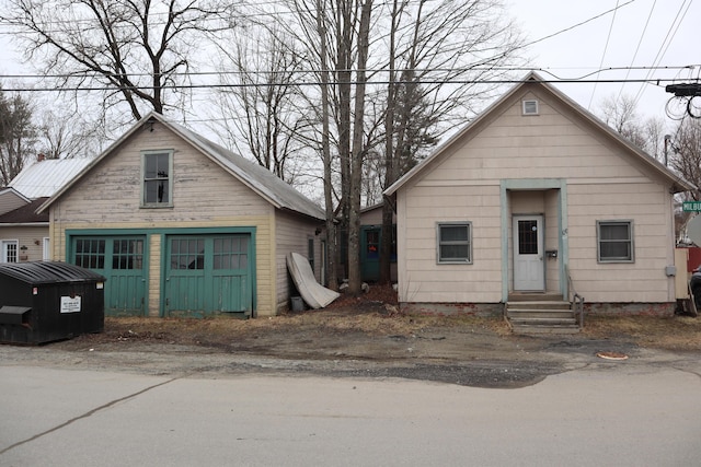 73 Milburn St, Skowhegan, ME 04976 - bungalow-style home featuring a detached garage and entry steps