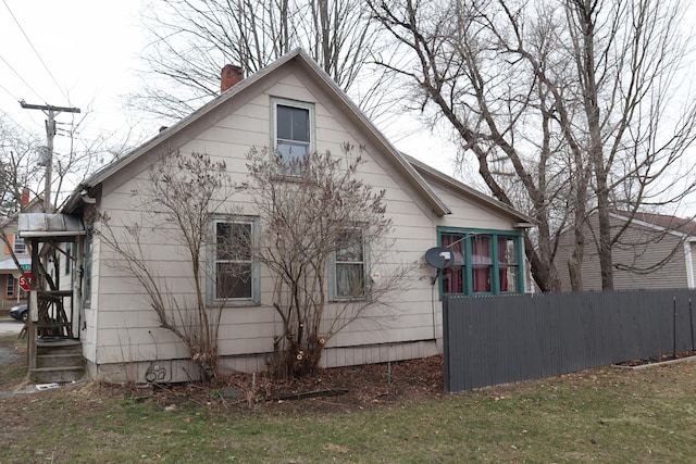 73 Milburn St, Skowhegan, ME 04976 - view of home's exterior featuring a chimney and fence