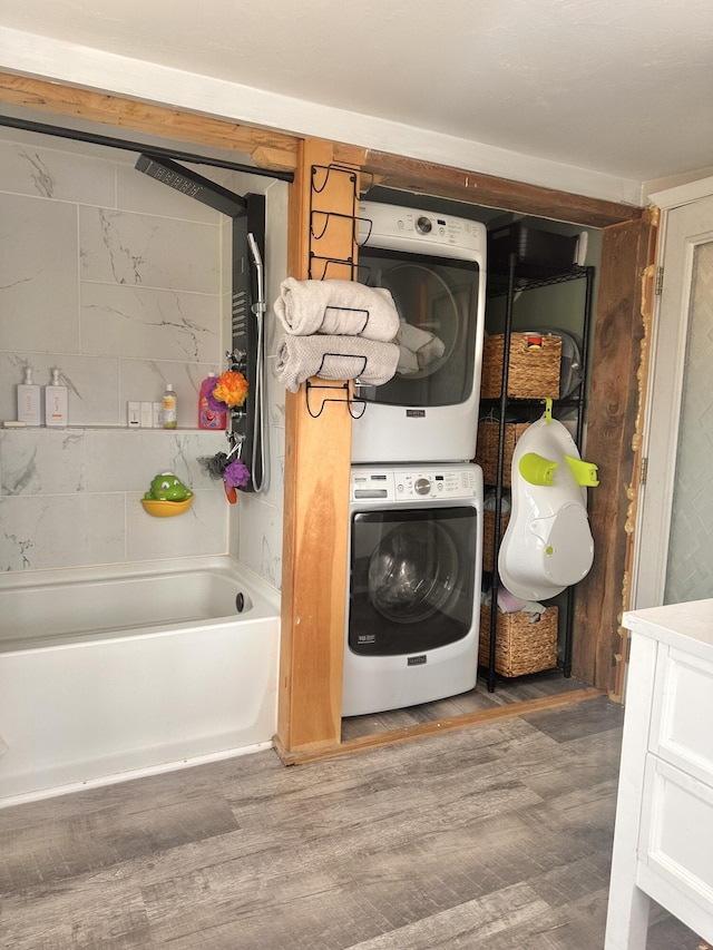 178 Frost Hill Rd, Norway, ME 04268 - laundry room with stacked washer and clothes dryer and wood finished floors