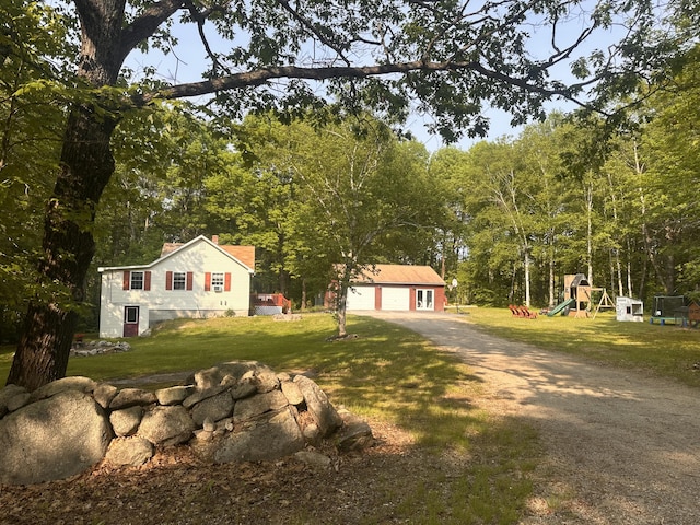 178 Frost Hill Rd, Norway, ME 04268 - view of front of home with a playground, a front yard, a detached garage, and an outdoor structure
