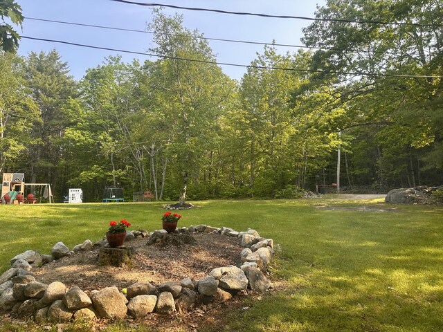 178 Frost Hill Rd, Norway, ME 04268 - view of grassy yard with a playground and a wooded view