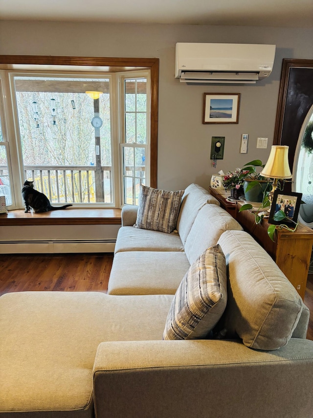 71 Reynolds Rd, Brooks, ME 04921 - living area with a wall mounted AC, baseboard heating, and wood finished floors