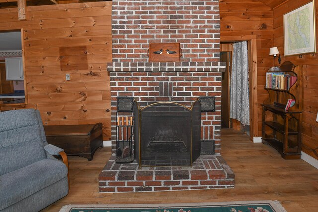 676 S High St, Bridgton, ME 04009 - details featuring baseboards, wood walls, wood finished floors, and a fireplace