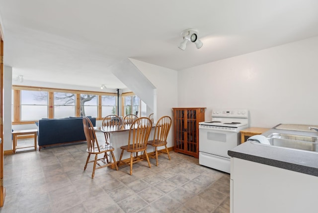 114 Birchmere Ln, Harpswell, ME 04079 - kitchen with white range with electric stovetop, a sink, dark countertops, and baseboards